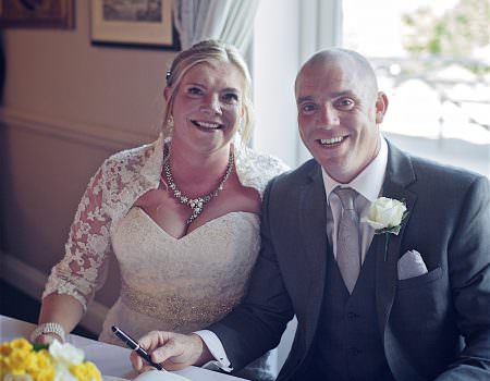Bride and groom signing register