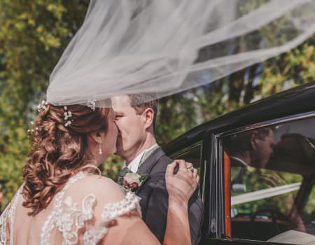 Bride and groom kissing at Rutland Water