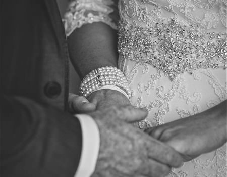 Bride and groom holding hands