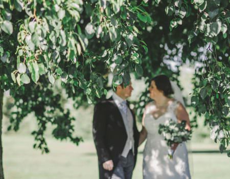 The bride and groom take shade