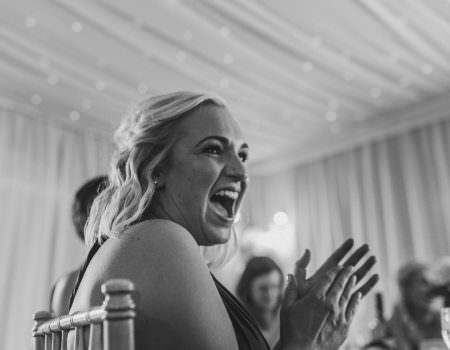 Bridesmaid laughs during the speeches