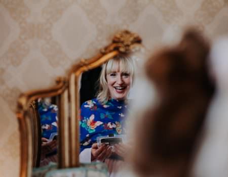 Bridesmaid having her hair done at Bassmead Manor Barn