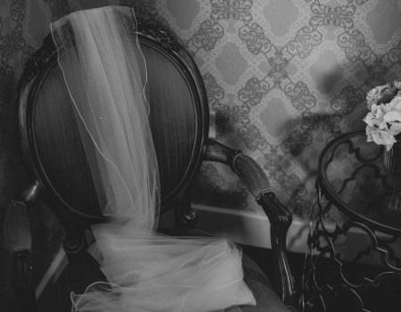 Bride's wedding veil draped on a chair
