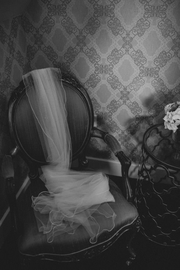 Bride's wedding veil draped on a chair