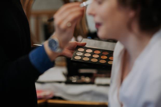 Bride having her makeup done at Bassmead Manor Barn