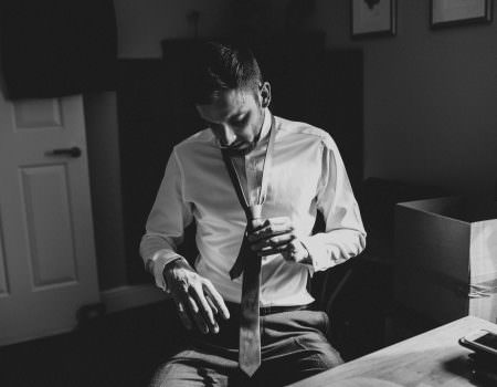 Groom tying his tie