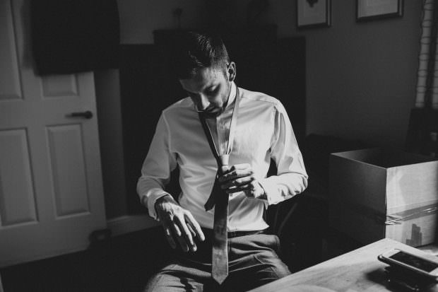 Groom tying his tie