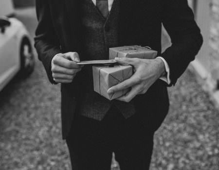 Groom getting his gift from the bride