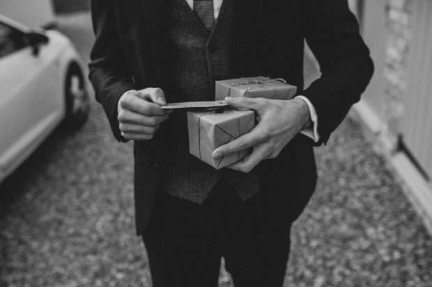 Groom getting his gift from the bride