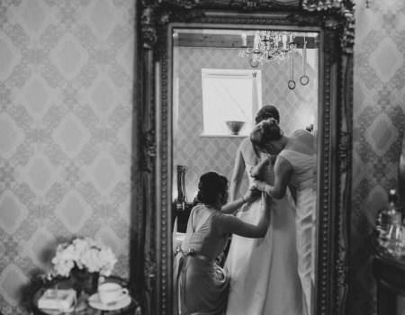 Bride getting ready in the mirror