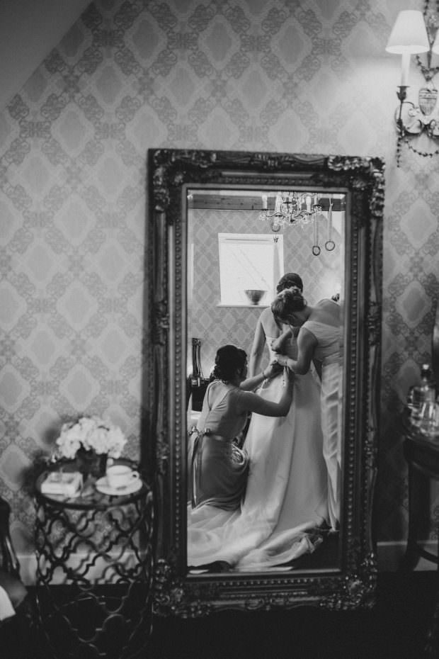 Bride getting ready in the mirror