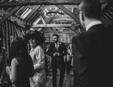 Groom coming in to the ceremony at Bassmead Manor Barn