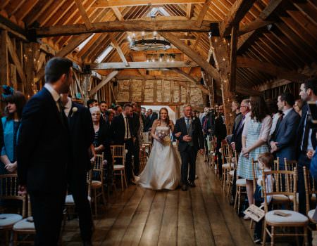 The bride enters the ceremony room at Bassmead Manor Barn