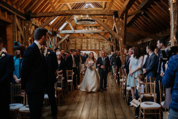 The bride enters the ceremony room at Bassmead Manor Barn