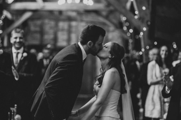 The bride and grooms first kiss at Bassmead Manor Barn