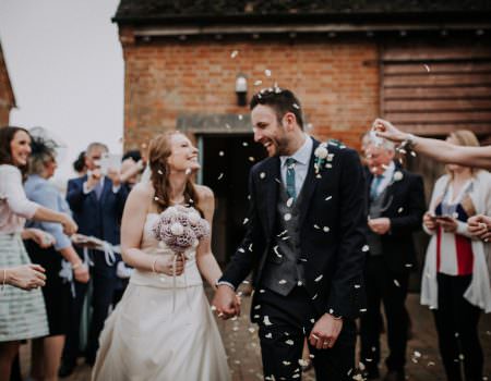Bride and groom exit the ceremony to confetti