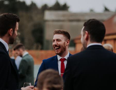 Guests having a laugh after the wedding
