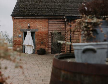 Wedding dress hanging at Bassmead Manor Barns
