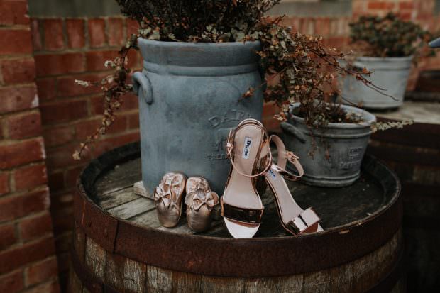 Brides shoes and flower girl shoes outside at Bassmead Manor Barns