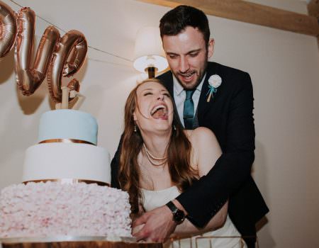 Bride and groom cutting the cake at Bassmead Manor Barn