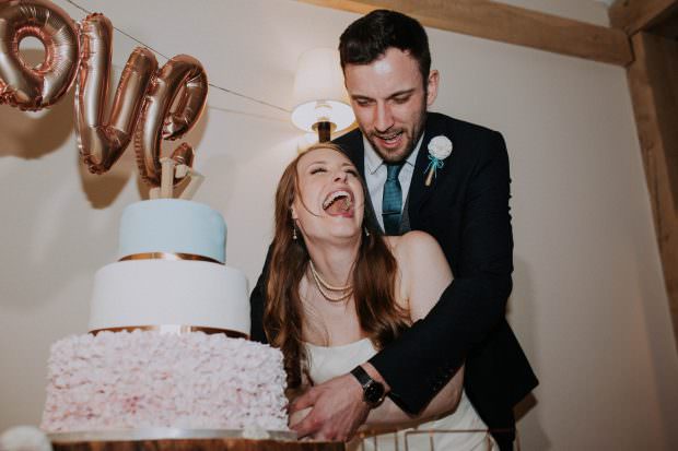 Bride and groom cutting the cake at Bassmead Manor Barn