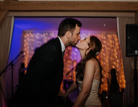 Bride and groom sharing a kiss on the dance floor