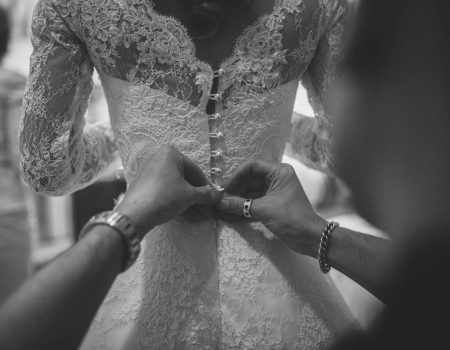 bride's dress being done up
