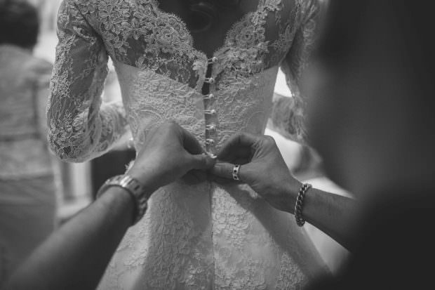 bride's dress being done up