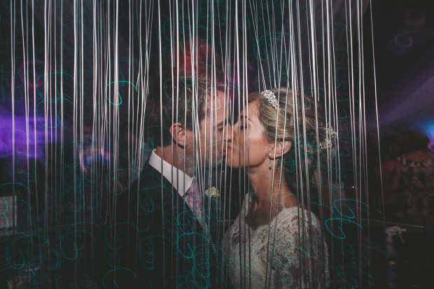 bride and groom kiss at wedding