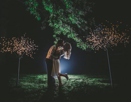 bride and groom night time kiss