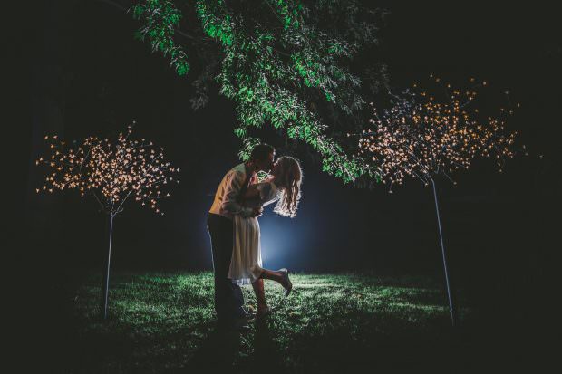 bride and groom night time kiss