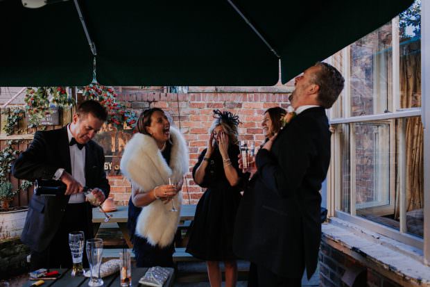 Guests laughing at the pub before wedding