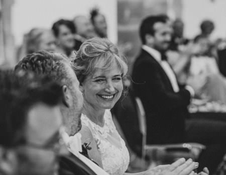 Bride laughs at wedding reading