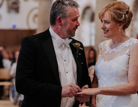 Bride and groom exchange rings at Oakham Castle Wedding Ceremony
