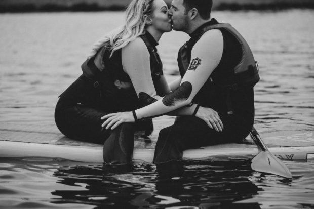 kiss on paddle boards